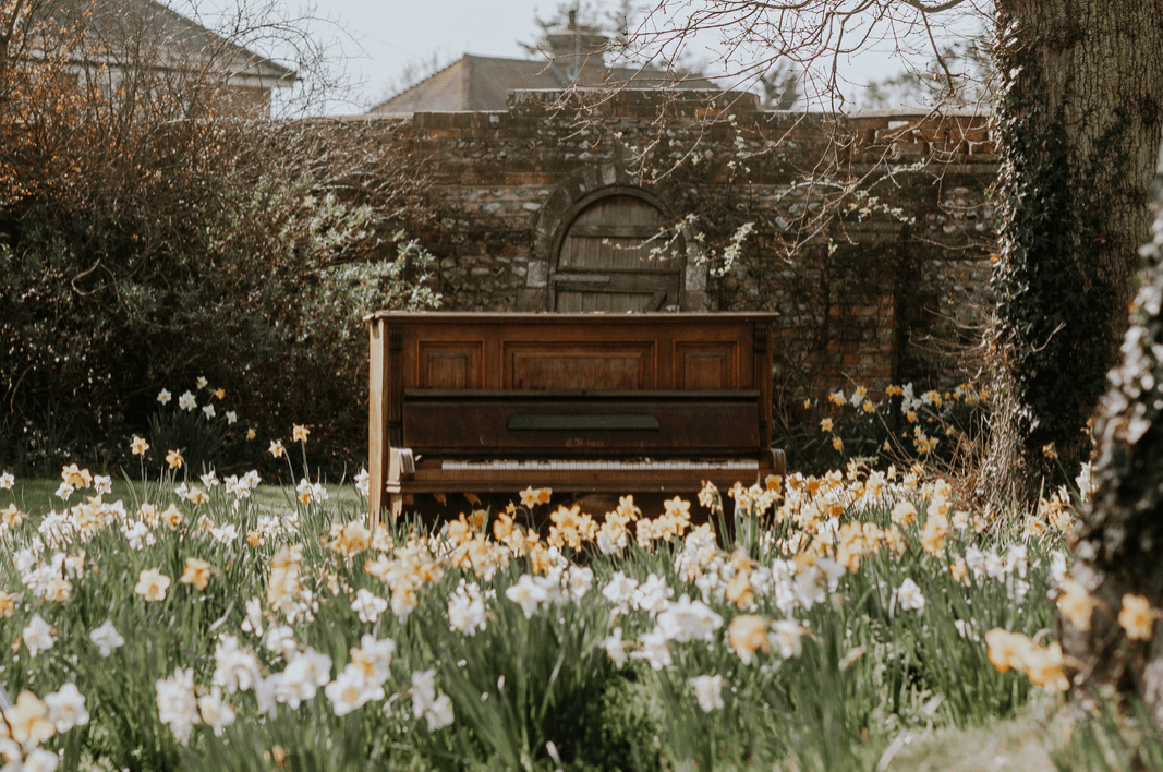 an outdoor piano in a garden